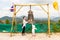 Child and mom near Thai gong in Phuket. Tradition asian bell in Buddhism temple in Thailand. Famous Big bell wish near Gold Buddha