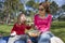 Child and mother eating pasta in park