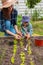 Child and mother gardening in vegetable garden in backyard