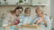 Child, mother and grandmother decorating cupcakes and talking in kitchen