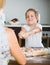 Child with mother making meat dumplings