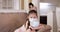 Child and mother in medical masks while coronavirus quarantined at home