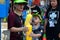 Child with mother refill water gun for celebrating Songkran festival