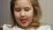 Child mouth bites rose donut. Closeup baby girl eating doughnut with glase. Delicious, sweet, sweettooth