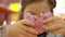 Child mouth bites rose donut. Closeup baby girl eating doughnut with glase. Delicious, sweet, sweettooth