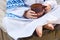 The child in national clothes holds in hand a clay mug with milk. Rural food.