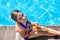 Child near the pool smears sunscreen. Selection focus.