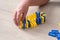 Child neatly lines up colorful domino blocks on the floor.