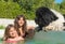 Child and newfoundland dog in swimming pool