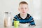 Child next to jar of oats, cup and bowl on table