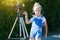 Child novice video blogger with a camera and a tripod