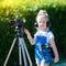 Child novice video blogger with a camera and a tripod