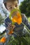 Child observing nature with a magnifying glass