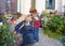 A child and an older woman hug and happily chat in the flower yard in front of the cottage. Grandmother greets her