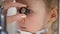 Child in ophthalmology clinic - optometrist diagnosis little blonde girl