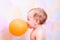 Child with orange balloon