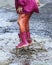 Child outdoor jump into puddle in boot after rain