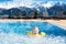 Child in outdoor swimming pool of alpine resort