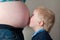 Child overshadowed by mothers pregnancy bump
