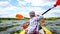 A child paddles on a kayak paddle. Active family vacation.