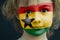 Child with a painted flag of Ghana