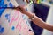 A child paints a cardboard ship.  with the words