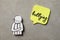 Child paper figure and sticker with word Bullying on stone surface, flat lay