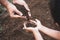 Child and parent holding soil and preparing soil for plant the tree