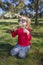 Child in park playing with big sunglasses