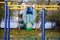 Child performs exercises on uneven bars outdoors