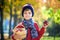 Child picking apples in autumn. Little baby boy playing in apple tree orchard. Kids pick fruit in a basket. Toddler eating fruits