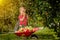 Child picking apples on a farm. Little boy playing in apple tree orchard. Kid pick fruit and put them in a wheelbarrow. Baby