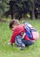 Child picking daisy flowers