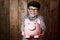 Child, piggy bank or excited in portrait by studio background, savings or finance lesson in youth. Boy, smile and face