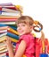 Child with pile of books.