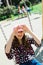 Child in pink cap swinging on Playground - heart shape