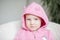 A child in a pink hoodie