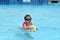 Child play with ball in swimming pool