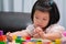 Child play with colorful wooden blocks on table. Concept is learned through play. Kid are 4 years old. Empty space to enter text