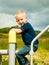 Child in playground kid in action boy play on leisure equipment