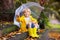 Child playing in autumn rain. Kid with umbrella