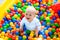 Child playing in ball pit on indoor playground