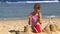 Child playing on beach and build sandcastles.