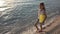 Child Playing on Beach at Sunset, Happy Kid Walking in Sea Waves Girl on Seaside