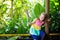 Child playing with bird feather. Kid at zoo