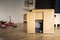 Child playing in a cardboard playhouse