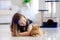 Child playing with cat at home. Kids and pets