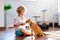 Child playing with cat at home. Kids and pets