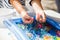 child playing with colored glass ball, playing game with colored balls