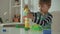 Child playing with colorful building plastic blocks constructor at home, tower falls, fail